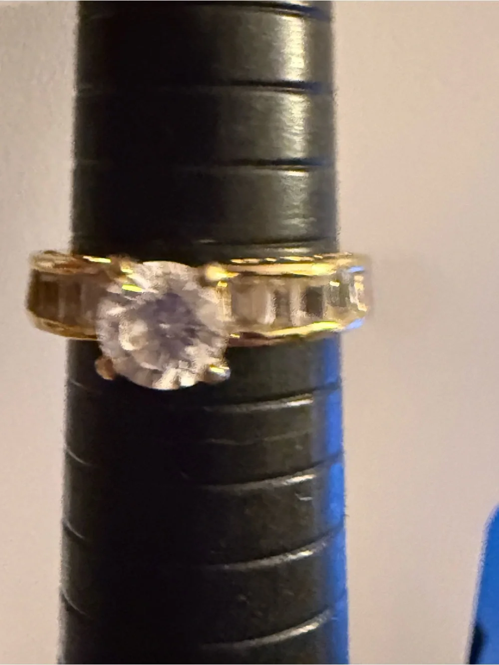 Gold tone Ring with Clear Round Center Stone and Baguette Accents